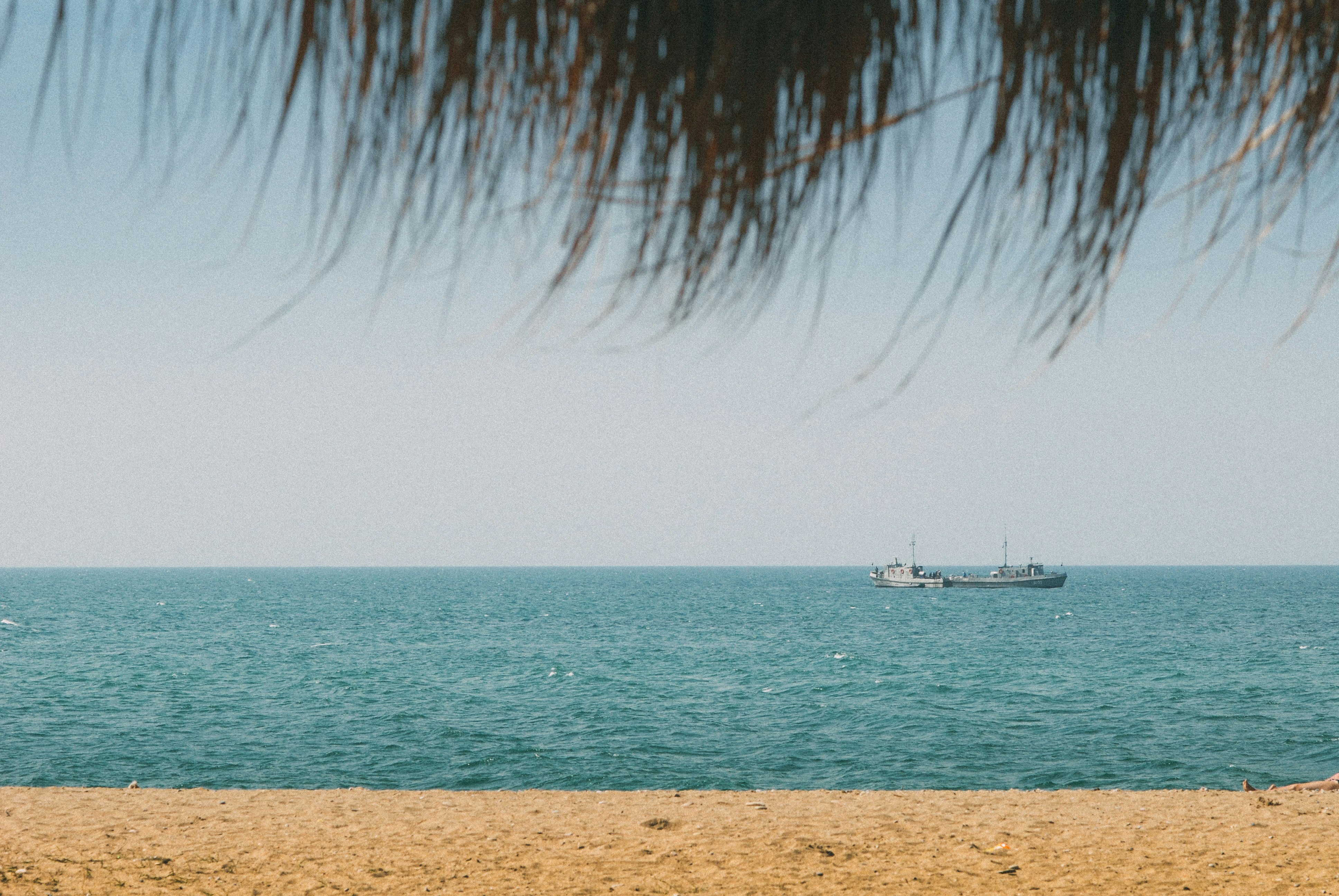 white boat on sea during daytime